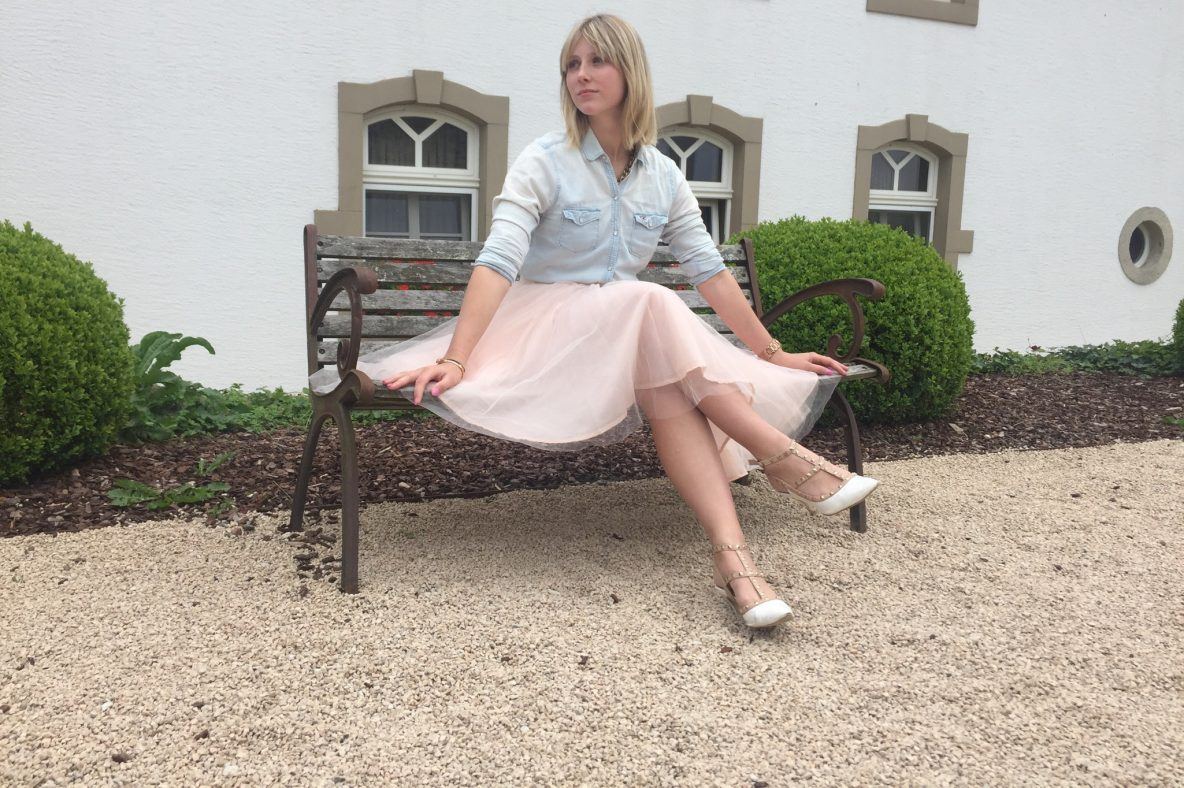 Maritsa van Iterson die op een bankje zit. Deze foto werd genomen op het domein van het kasteel Chateau D'Urspelt