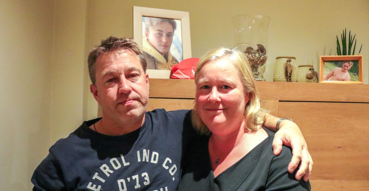 Veerle en haar man bij een foto van hun overleden zoon