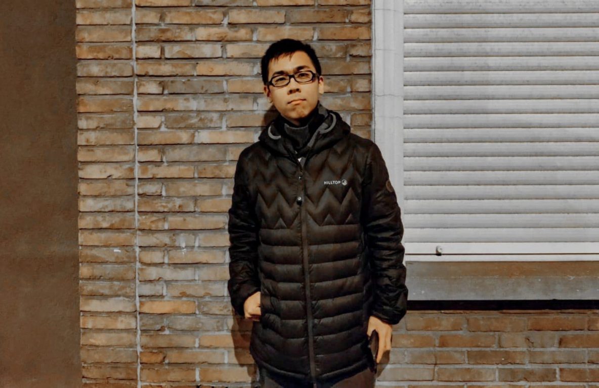 A picture of chris, the interviewee of this article, in front of a brick wall